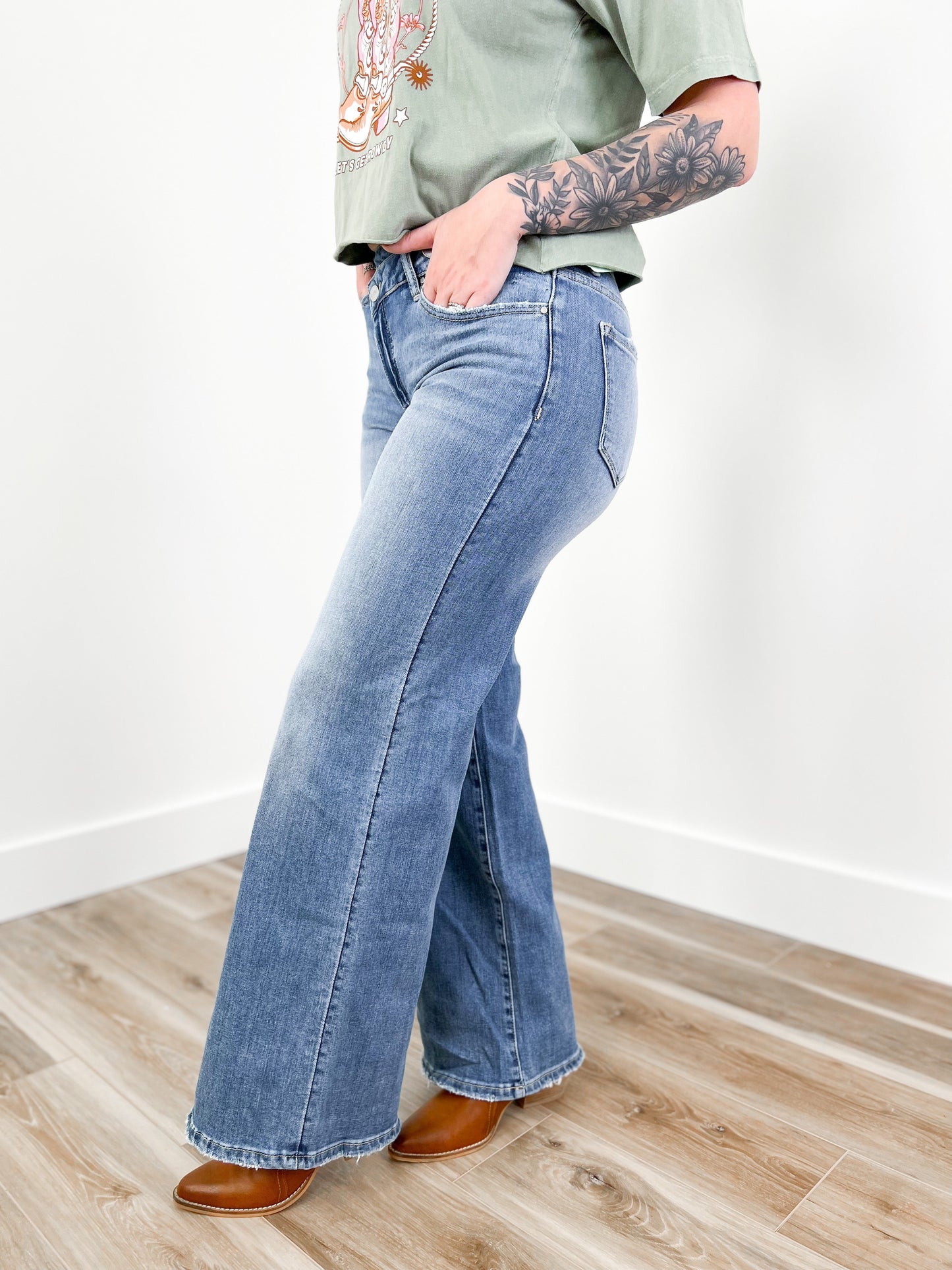 Risen Mid Rise Medium Wash Wide Leg Crossover Jeans